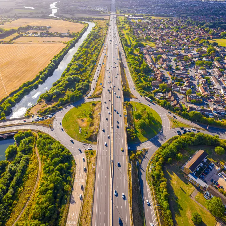 Aerial drone view of a major motorway junction and roundabout near Slough Berkshire, representing the primary SL2 service area for MJC Auto Recovery.